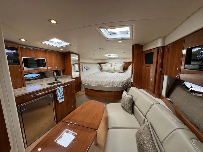 Slide: The Image of 2018 Formula 34 PC yacht interior with kitchen, bed, and seating area. - 12