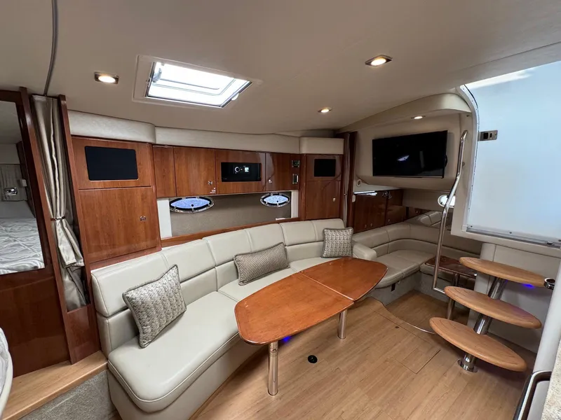 Slide: The Image of 2018 Formula 34 PC yacht interior with beige seating, wooden table, and modern amenities. - 14