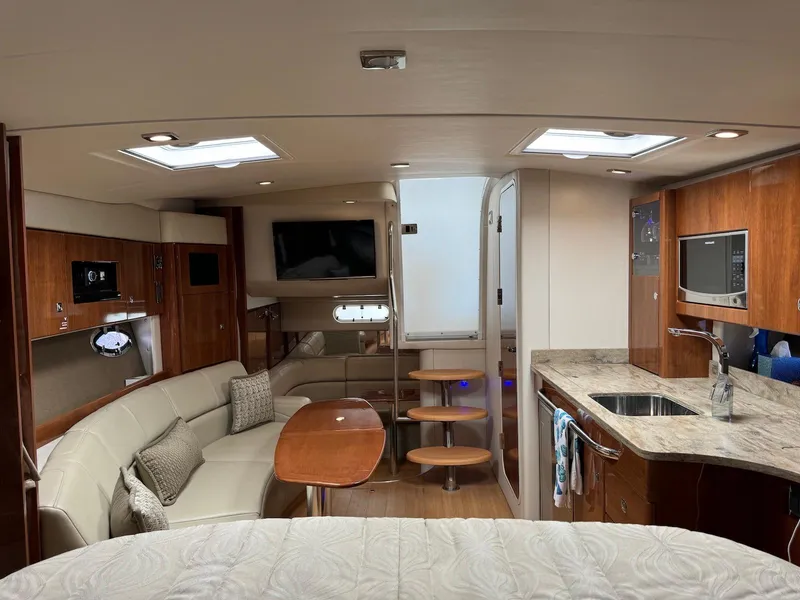 Slide: The Image of 2018 Formula 34 PC yacht interior with modern kitchen, seating area, and entertainment system. - 16