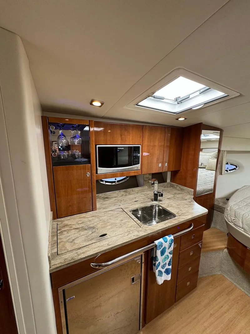 Slide: The Image of 2018 Formula 34 PC yacht interior with modern kitchen and wooden cabinetry. - 17