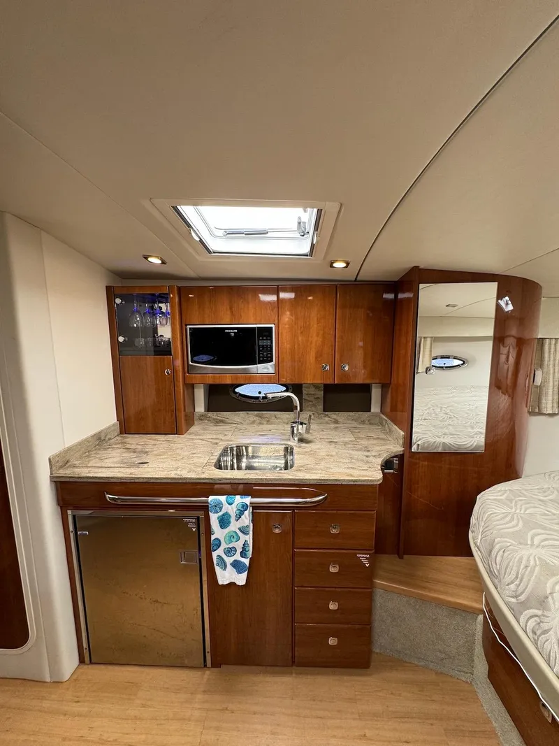 Slide: The Image of 2018 Formula 34 PC yacht interior with kitchenette, wood cabinetry, and modern amenities. - 22