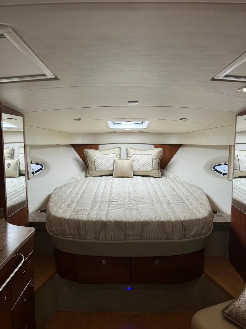 Slide: The Image of 2018 Formula 34 PC yacht interior with luxurious bed and elegant wood accents. - 25