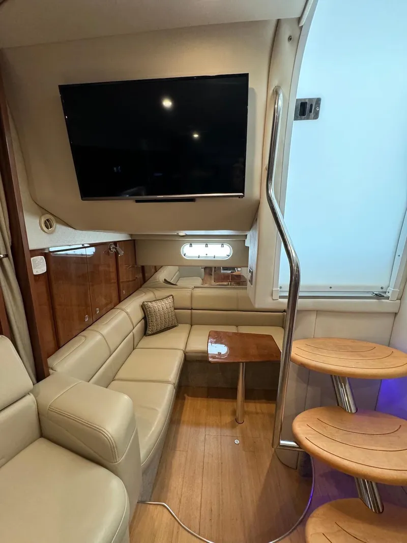 Slide: The Image of 2018 Formula 34 PC yacht interior with leather seating, TV, and wooden steps. - 26