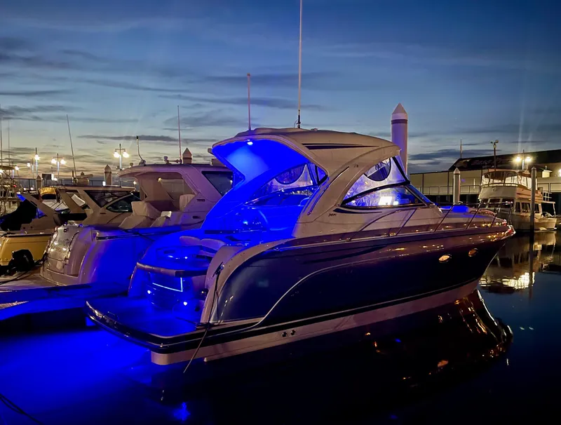 Slide: The Image of 2018 Formula 34 PC yacht illuminated with blue lights at dusk in a marina. - 3