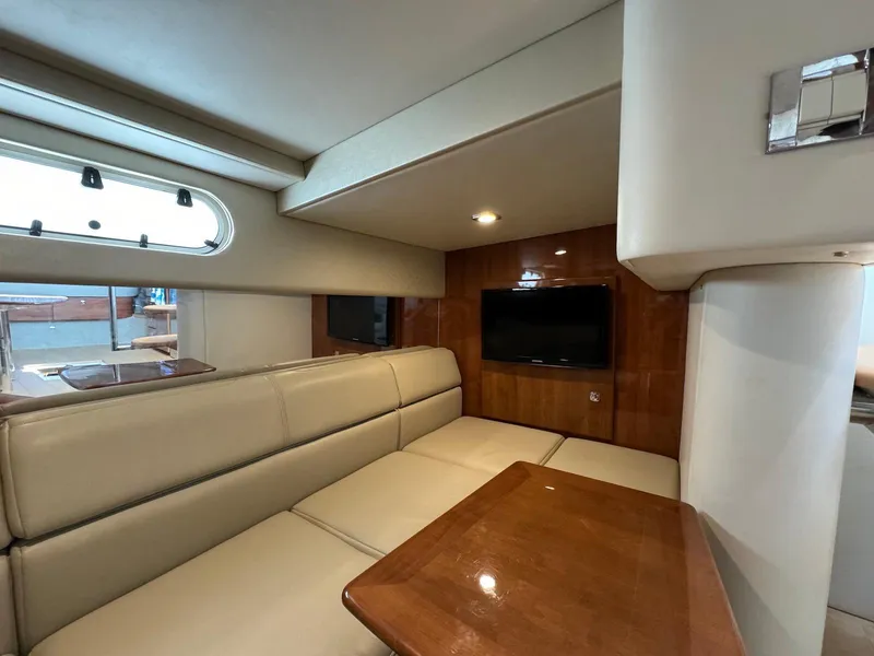 Slide: The Image of Interior of 2018 Formula 34 PC yacht with beige seating and wooden table. - 31