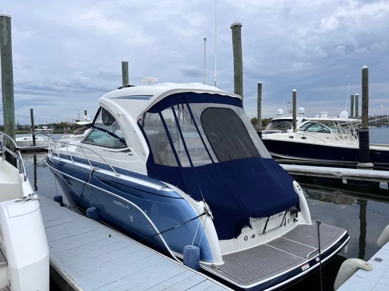 Slide: The Image of 2018 Formula 34 PC boat docked at marina under cloudy sky. - 6