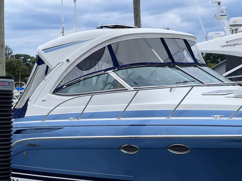 Slide: The Image of 2018 Formula 34 PC boat with blue and white exterior docked at marina. - 9