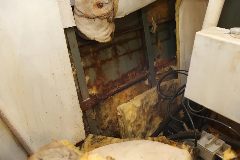 Slide: The Image of Interior view of 1988 Winston Knauss 64 boat showing rust and insulation. - 10