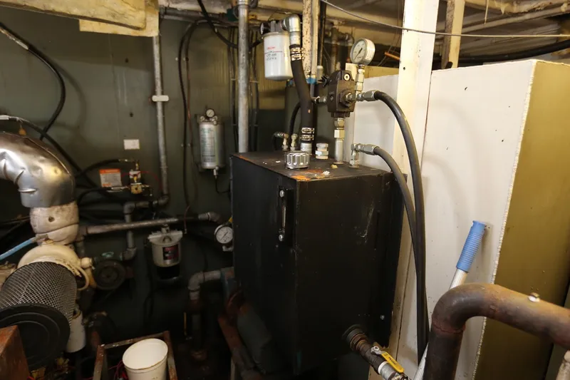 Slide: The Image of Engine room of 1988 Winston Knauss 64 Dinner or Party Boat, featuring mechanical equipment and pipes. - 11