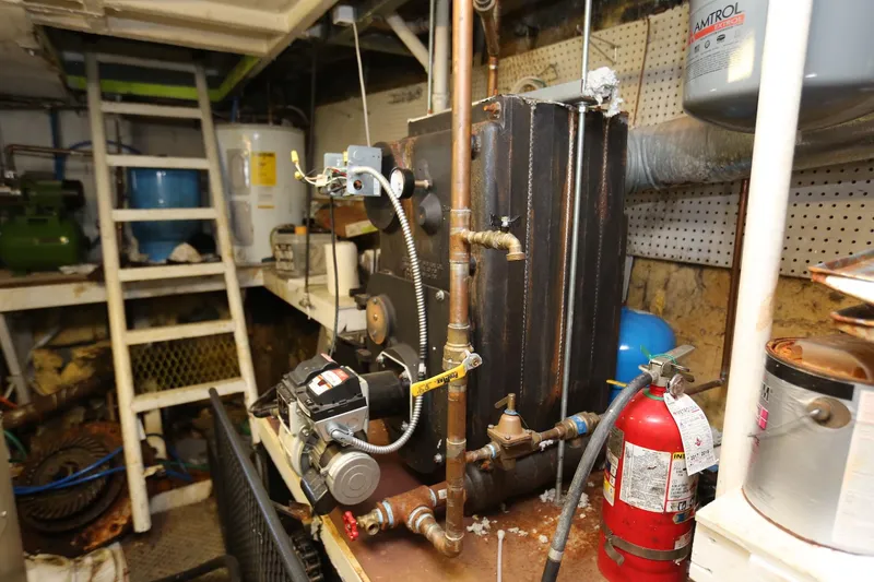 Slide: The Image of Engine room of 1988 Winston Knauss 64 party boat with machinery and fire extinguisher. - 14