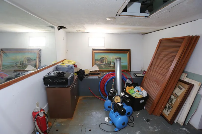 Slide: The Image of Storage room on 1988 Winston Knauss 64 boat with paintings and equipment. - 17