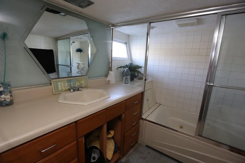 Slide: The Image of Bathroom on 1988 Winston Knauss 64 Party Boat with vanity and shower. - 19