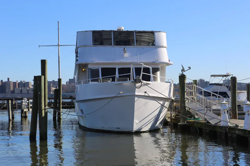 Slide: The Image of 1988 Winston Knauss 64 Dinner or Party Boat docked at marina, clear blue sky. - 2