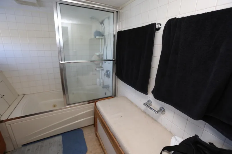 Slide: The Image of Bathroom interior of 1988 Winston Knauss 64 party boat with shower and towels. - 20