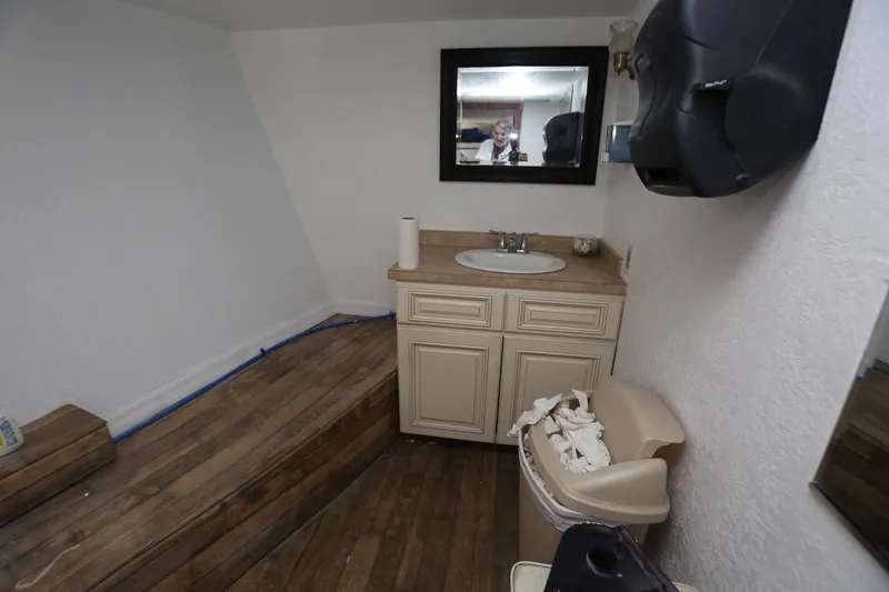 Slide: The Image of Restroom interior of 1988 Winston Knauss 64 Party Boat with wooden flooring. - 25
