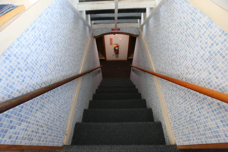 Slide: The Image of Staircase on 1988 Winston Knauss 64 Party Boat with blue mosaic walls. - 27