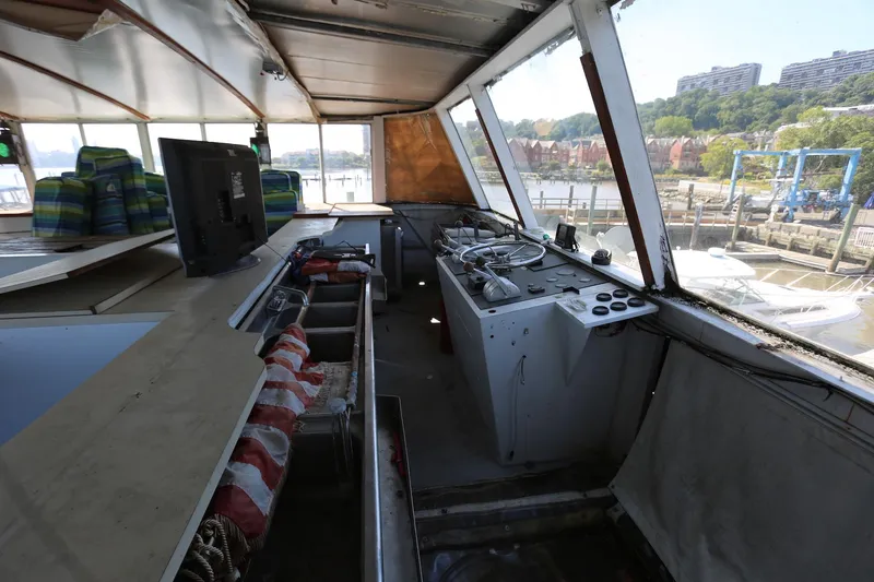 Slide: The Image of Interior of 1988 Winston Knauss 64 party boat with control panel and seating. - 32