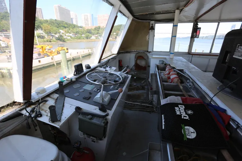 Slide: The Image of Cockpit of 1988 Winston Knauss 64 Party Boat with steering wheel and control panel. - 33