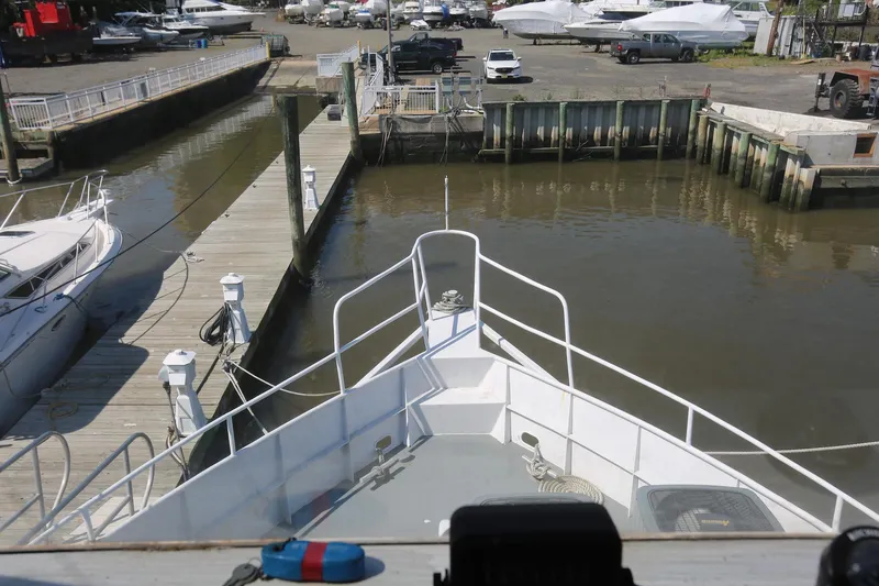 Slide: The Image of Bow view of 1988 Winston Knauss 64 party boat docked at marina. - 34