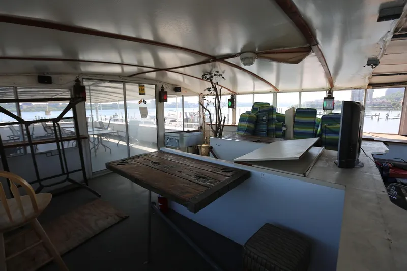 Slide: The Image of Interior of 1988 Winston Knauss 64 party boat with seating and wooden table. - 35