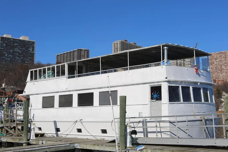 Slide: The Image of Custom Winston Knauss 64 Dinner or Party Boat, 1988, docked with cityscape background. - 4
