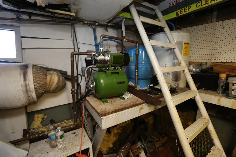 Slide: The Image of Engine room of 1988 Winston Knauss 64 party boat with machinery and ladder. - 8