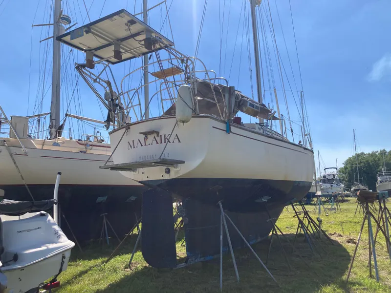 The Image of 1987 Island Packet 38 sailboat on land, sunny day. - 0