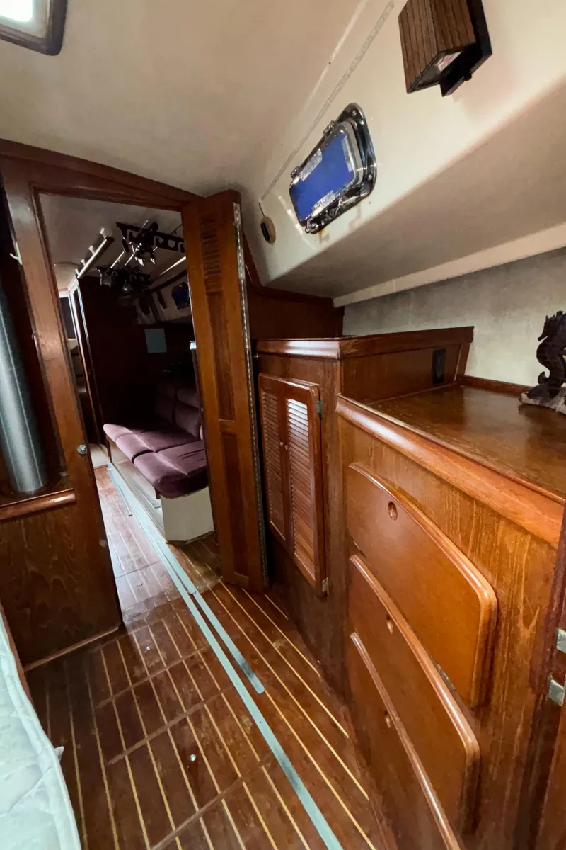 Slide: The Image of 1987 Island Packet 38 interior with wooden cabinetry and seating area. - 17