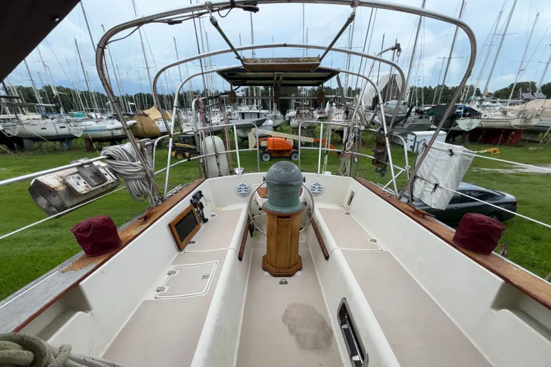 Slide: The Image of 1987 Island Packet 38 sailboat cockpit with navigation equipment, docked in a marina. - 30