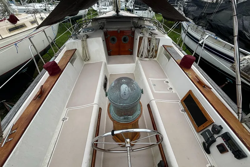 Slide: The Image of Cockpit of 1987 Island Packet 38 sailboat with wooden accents and navigation equipment. - 34