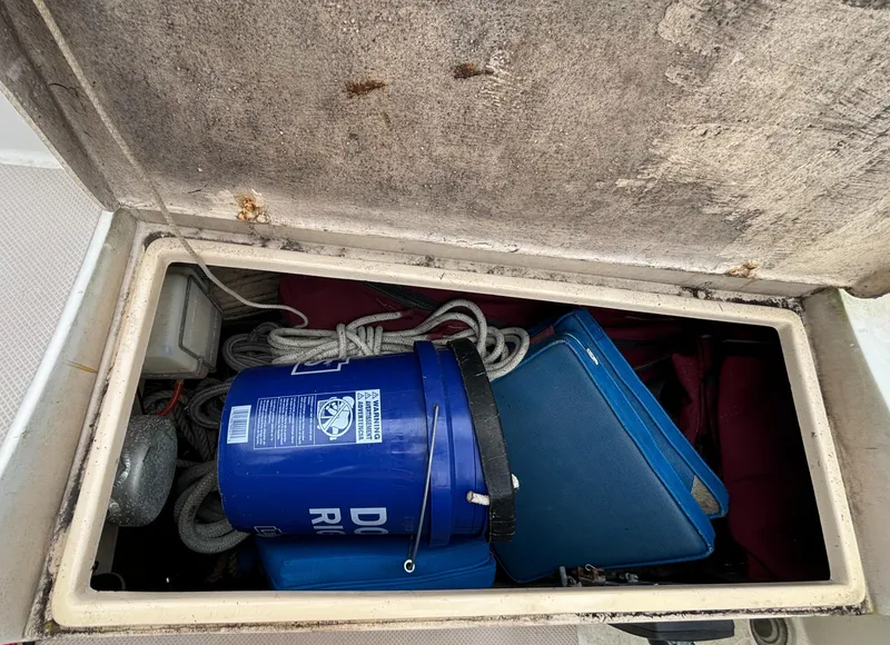 Slide: The Image of Storage compartment on a 1987 Island Packet 38 sailboat with ropes and a blue bucket. - 36