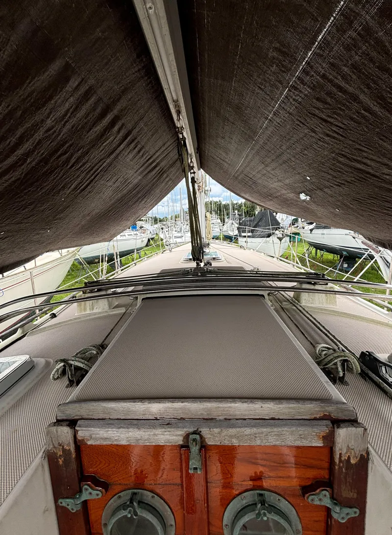 Slide: The Image of 1987 Island Packet 38 sailboat deck view with wooden hatch and rigging. - 41