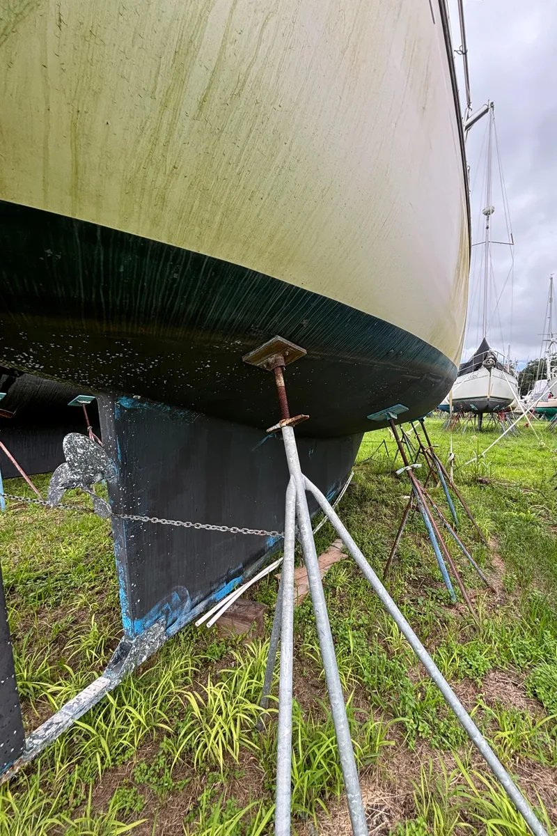 Slide: The Image of 1987 Island Packet 38 sailboat on stands in dry dock. - 48