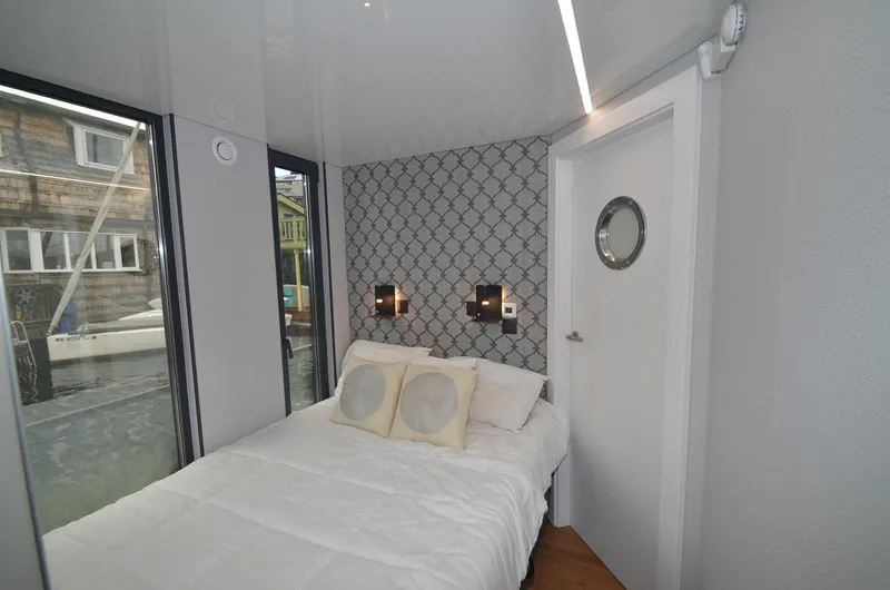 Slide: The Image of Modern 2024 La Mare houseboat bedroom with stylish decor and large windows. - 17
