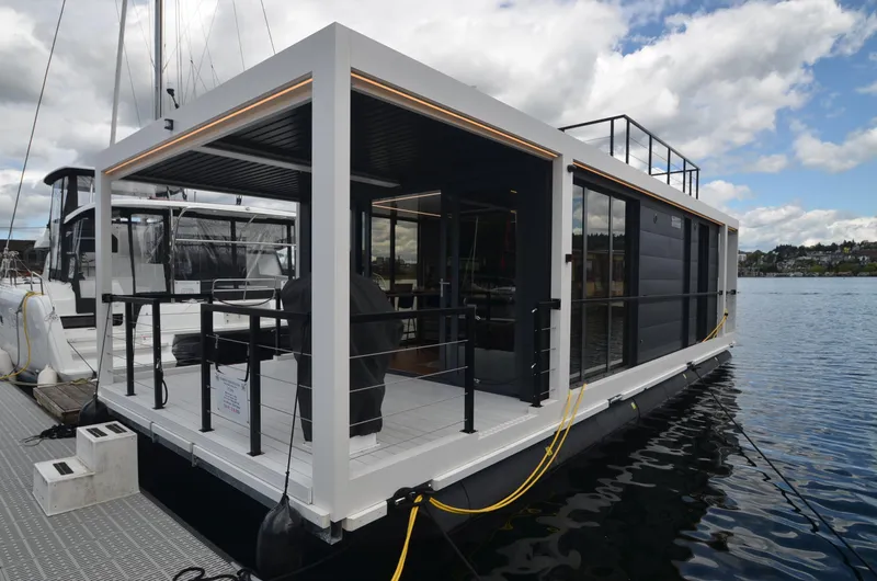 Slide: The Image of 2024 La Mare Modern 11 houseboat on water, featuring sleek design and spacious deck. - 2