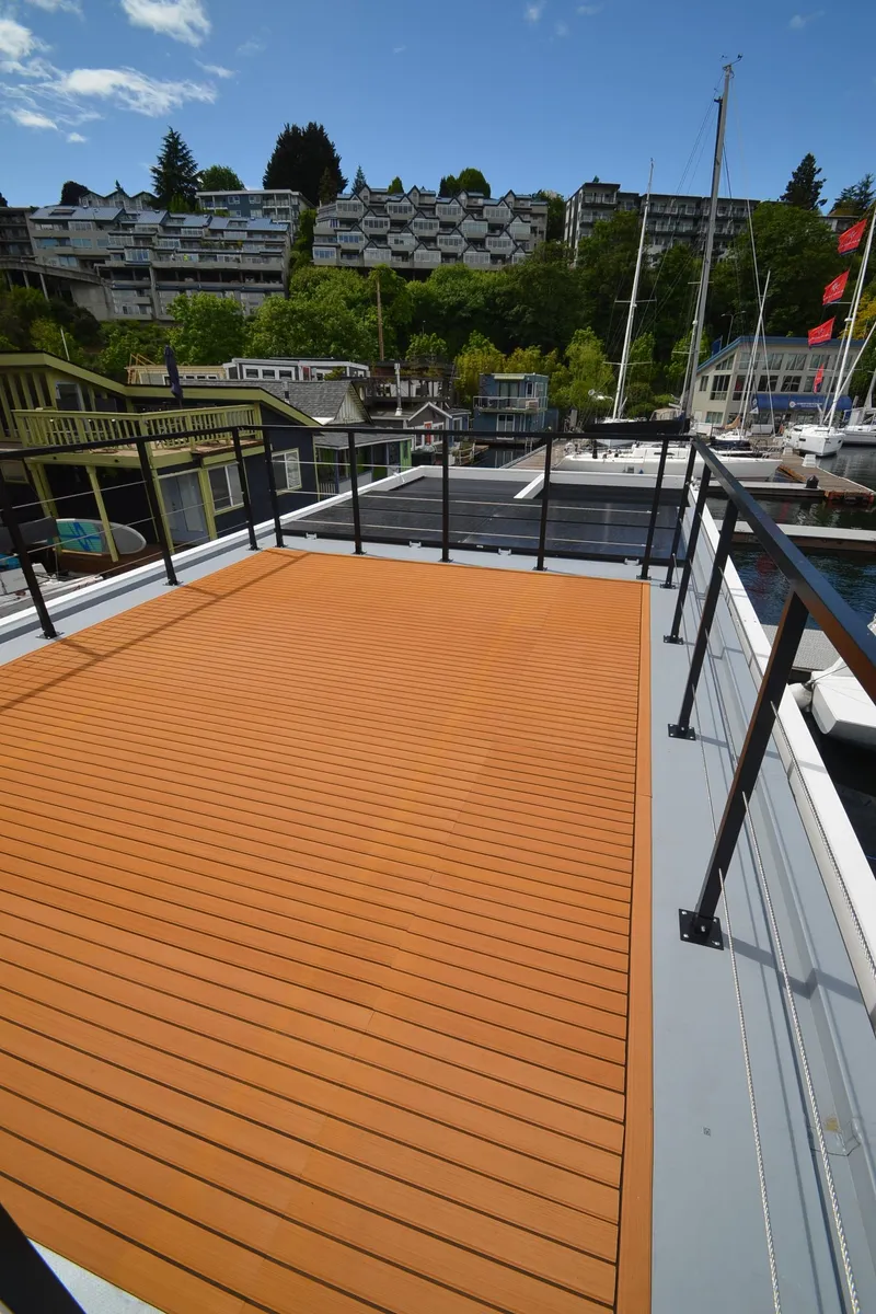 Slide: The Image of Modern La Mare 2024 houseboat with spacious deck, scenic marina view, and sleek design. - 35