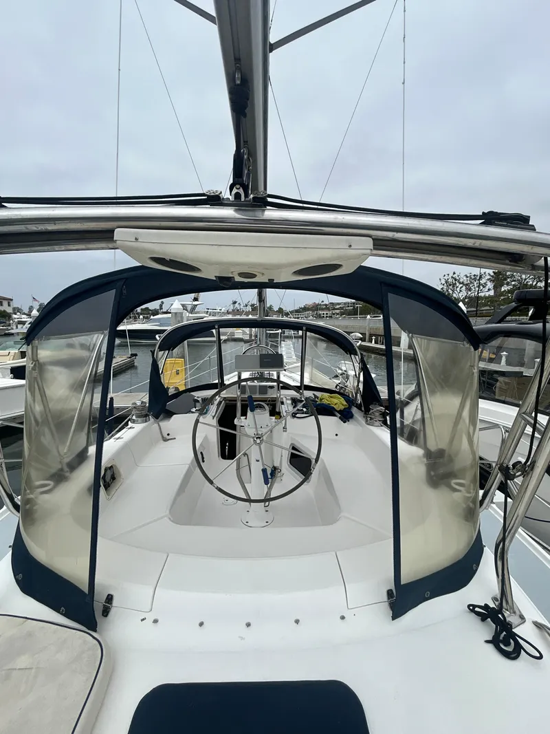 Slide: The Image of 2000 Hunter Passage 420 sailboat cockpit with steering wheel, docked in marina. - 11