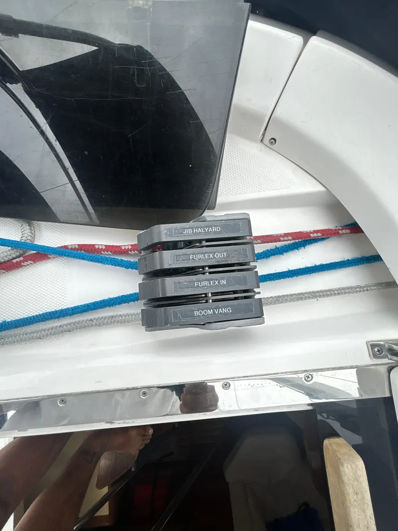 Slide: The Image of Control panel on a 2000 Hunter Passage 420 sailboat with labeled switches and ropes. - 16