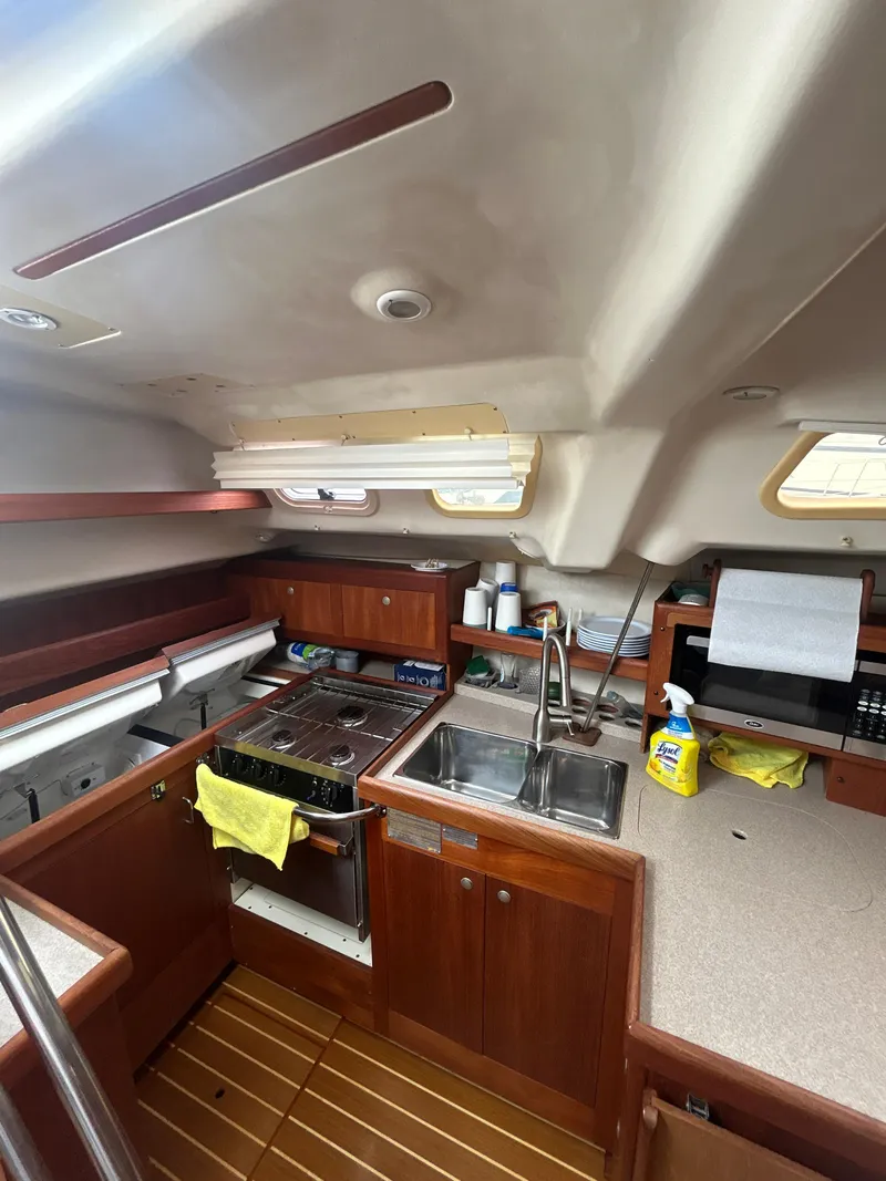 Slide: The Image of Interior of 2000 Hunter Passage 420 sailboat with kitchen and wooden cabinetry. - 19