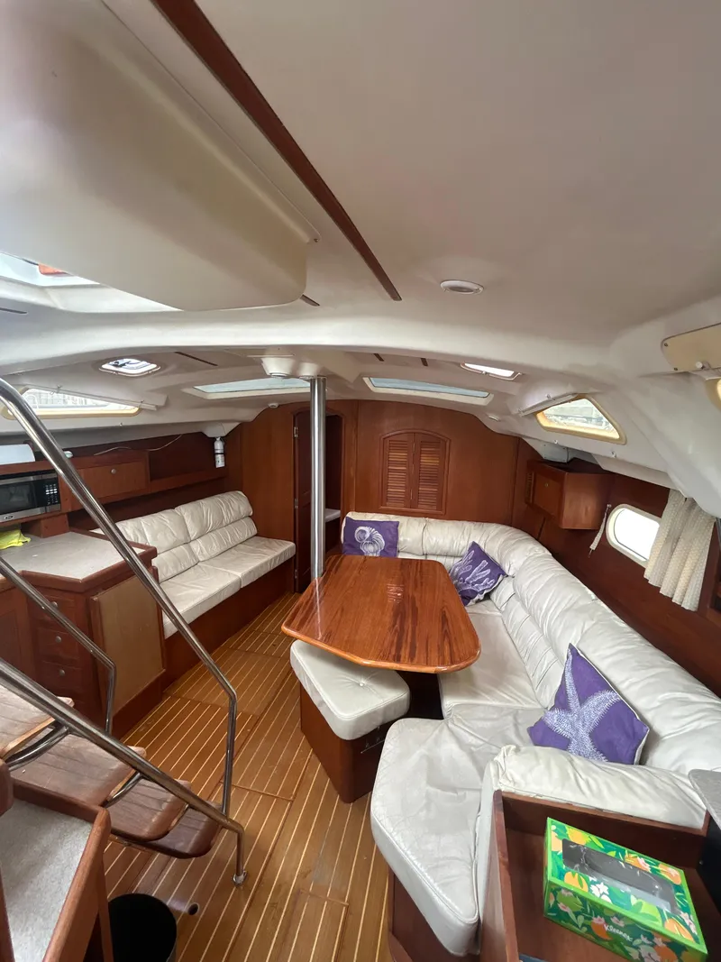 Slide: The Image of Interior of 2000 Hunter Passage 420 yacht with cozy seating and wooden table. - 21