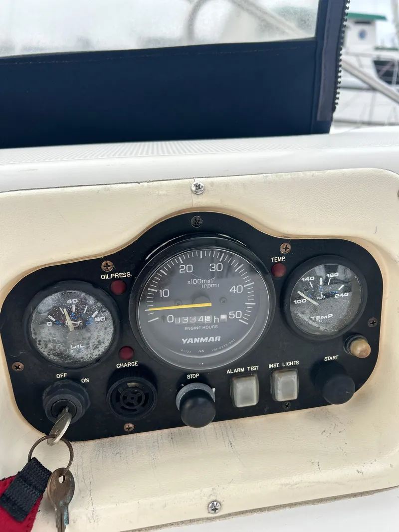 Slide: The Image of Close-up of a 2000 Hunter Passage 420 boat dashboard with Yanmar gauges and controls. - 23