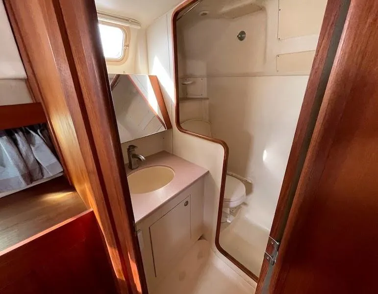 Slide: The Image of Bathroom interior of 2000 Hunter Passage 420 yacht, featuring sink and shower. - 9