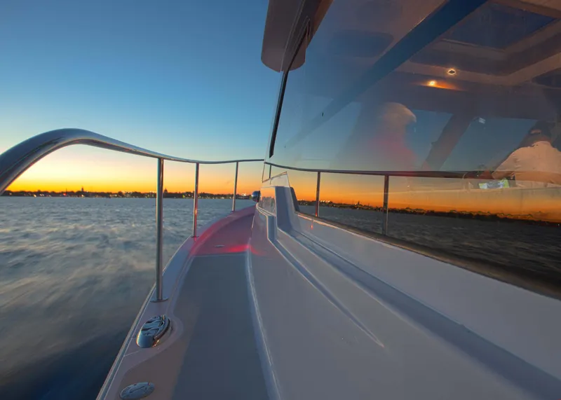 Slide: The Image of 2024 True North 34 boat cruising at sunset on calm waters. - 17