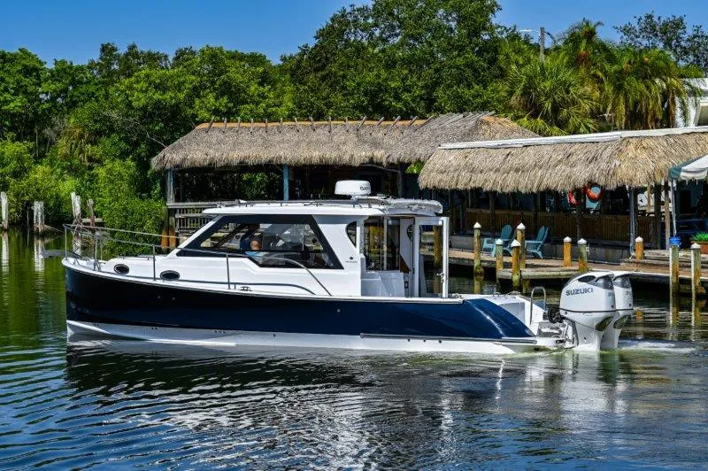 Slide: The Image of 2024 True North 34 boat cruising near a tropical dock. - 20
