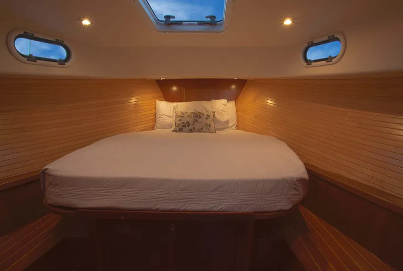 Slide: The Image of Luxurious cabin interior of 2024 True North 34 yacht with cozy bedding. - 5