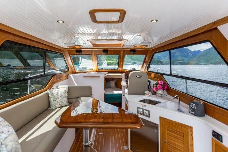 Slide: The Image of Luxurious 2024 True North 34 yacht interior with panoramic windows and elegant wood finishes. - 6