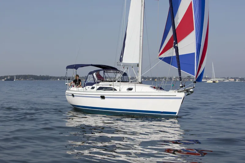 Slide: The Image of 2024 Catalina 355 sailboat with colorful spinnaker on calm water. - 17