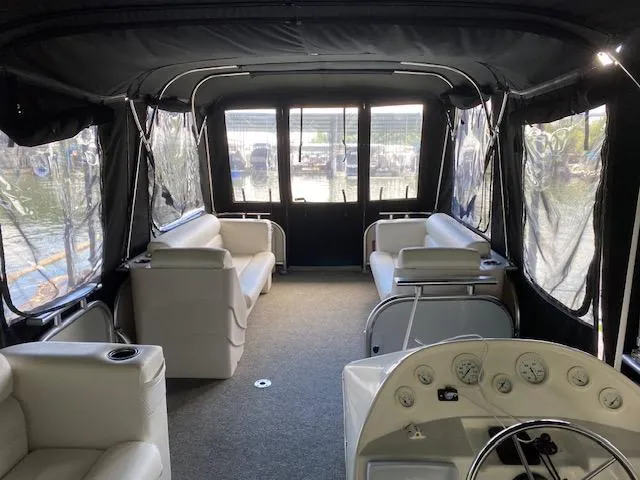 Slide: The Image of Interior of 1988 Sun Tracker PARTY BARGE with white seating and enclosed canopy. - 11