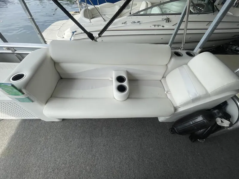 Slide: The Image of White seating on 1988 Sun Tracker PARTY BARGE with cup holders, docked by water. - 28