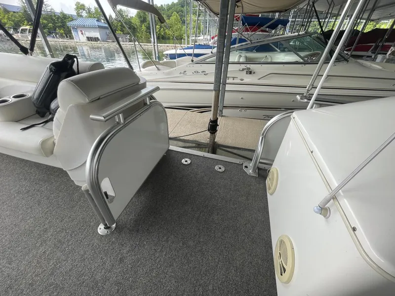 Slide: The Image of 1988 Sun Tracker PARTY BARGE interior with seating and railing, docked at marina. - 29